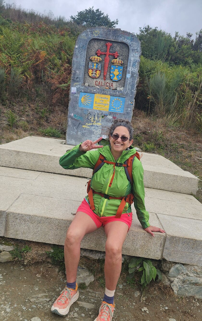 Alaina Schwartz beside the Galicia waymarker on the Camino de Santiago