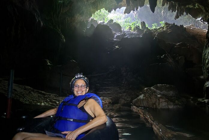 Alaina Schwartz cave tubing through an underground river